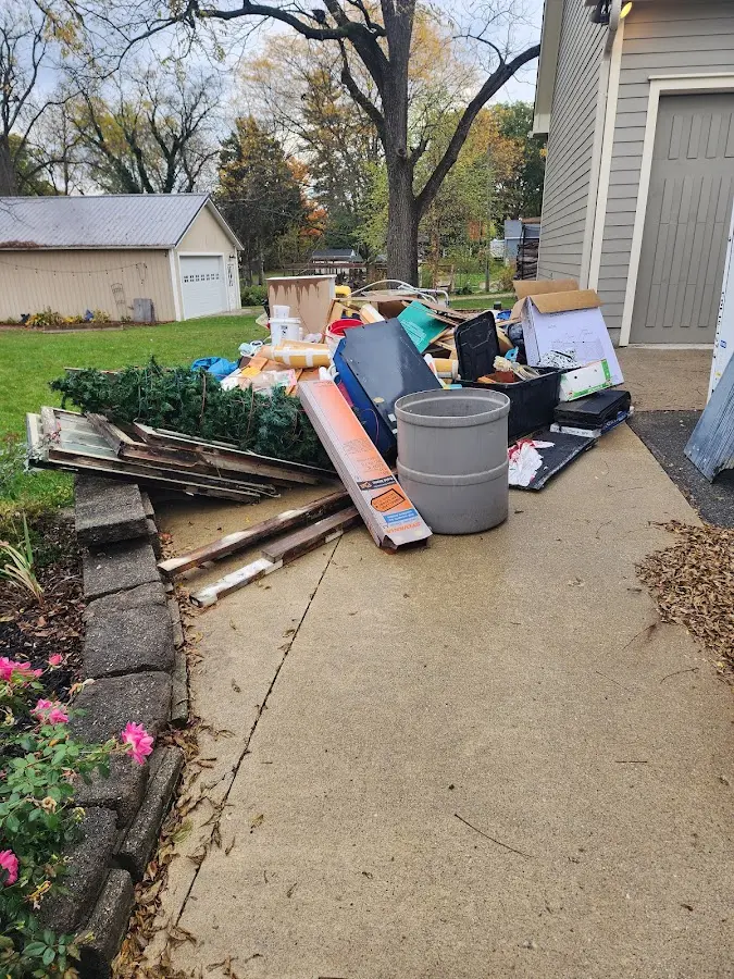 Dumpster being loaded with debris for Demolition Dumpster Rental in College